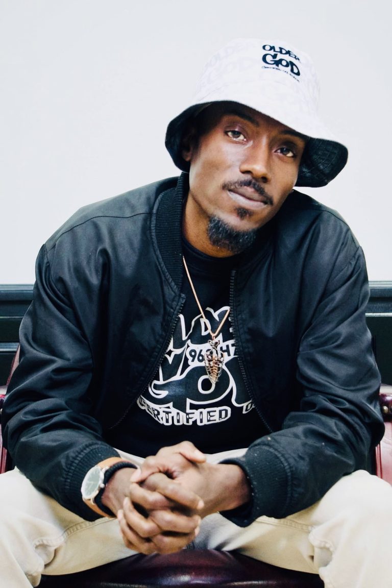 Older god white bucket hat black jacket